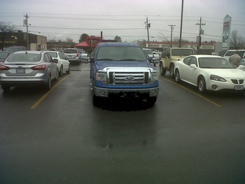 brand new truck in two parking spots